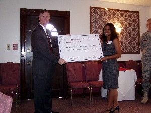 India Grant receives her scholarship check from Col. Stidham in May.
